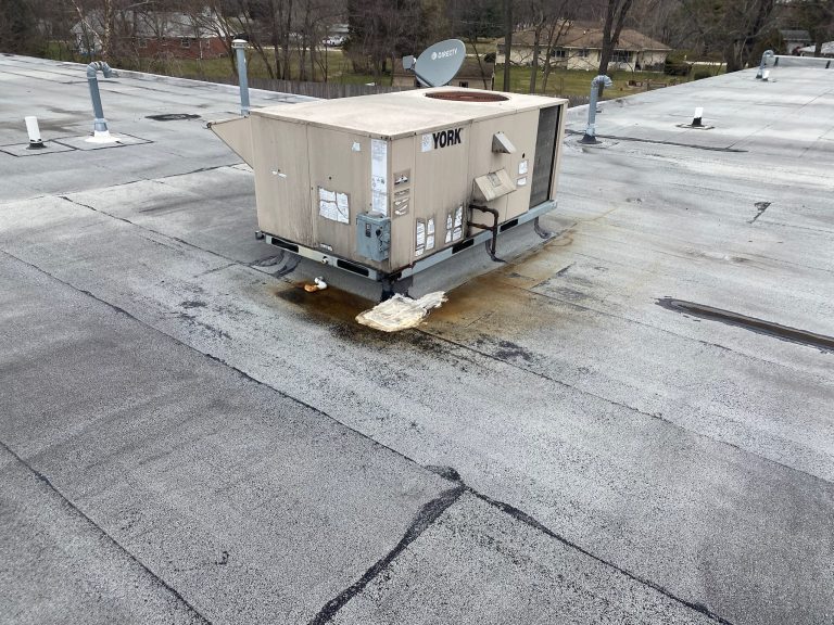 roof bros restoration illinois commercial roof leak 001 2 - Roof Bros Restoration - roofing gallery wisconsin illinois A rooftop YORK HVAC unit on a commercial flat roof with visible staining and pooled water residue around its base on the m...