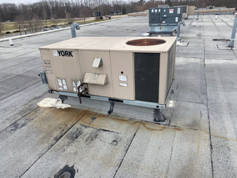 roof bros restoration illinois commercial roof leak 003 2 - Roof Bros Restoration - roofing gallery wisconsin illinois A YORK-branded rooftop HVAC packaged unit on a commercial flat roof with visible water staining and membrane discoloration...