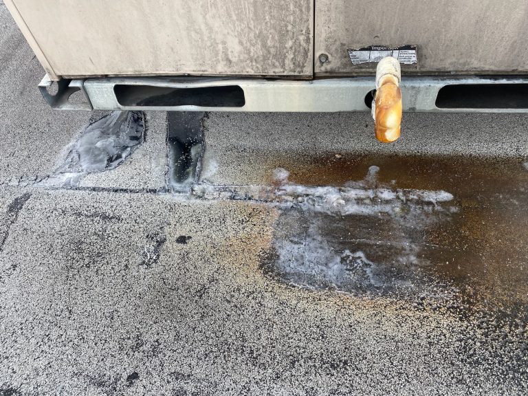 roof bros restoration illinois commercial roof leak 007 2 - Roof Bros Restoration - roofing gallery wisconsin illinois A close-up of a flat roof surface near an HVAC unit base with a drain pipe and visible black sealant patching and water st...