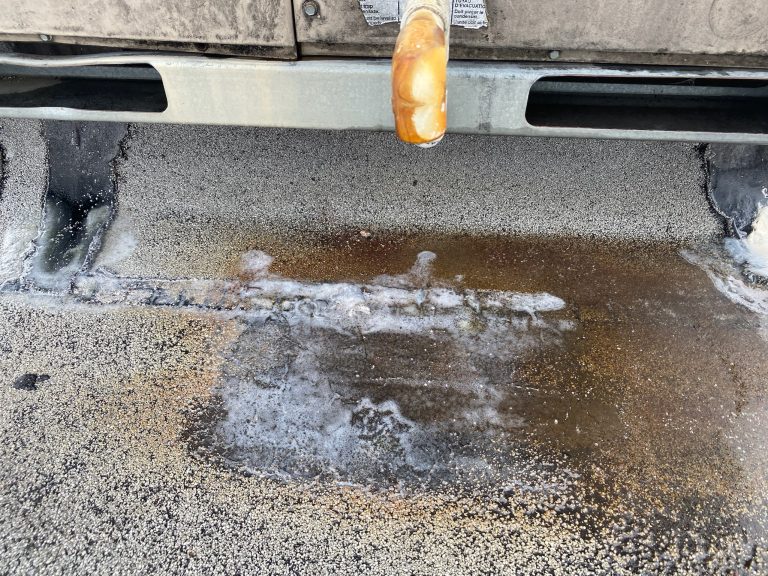 roof bros restoration illinois commercial roof leak 008 2 - Roof Bros Restoration - roofing gallery wisconsin illinois A close-up of a flat commercial roof showing a drain pipe and visible water pooling, residue, and staining on the membrane...