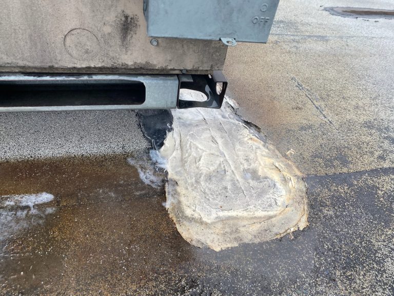 roof bros restoration illinois commercial roof leak 009 2 - Roof Bros Restoration - roofing gallery wisconsin illinois A close-up of an HVAC unit base on a flat roof with an electrical disconnect box and a large patch of weathered insulation...