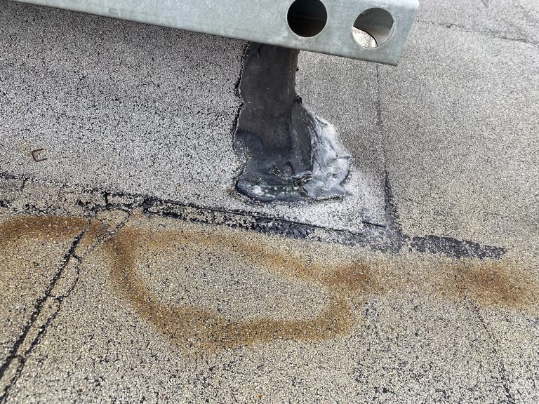 roof bros restoration illinois commercial roof leak 012 - Roof Bros Restoration - roofing gallery wisconsin illinois A close-up of a flat commercial roof showing the base of a metal support stand with black sealant patches and visible stai...