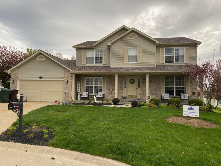 roof bros restoration illinois completed roof 003 - Roof Bros Restoration - roofing gallery wisconsin illinois A two-story tan brick and beige siding home with an attached two-car garage has a Roof Bros Restoration yard sign placed o...