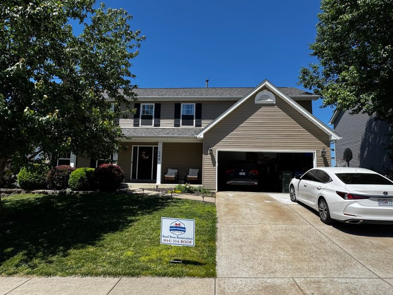 roof bros restoration illinois completed roof 005 - Roof Bros Restoration - roofing gallery wisconsin illinois A two-story home with tan siding and an attached garage has a Roof Bros Restoration (844) 314-ROOF yard sign on the front...