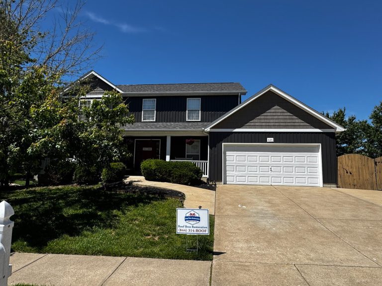 roof bros restoration illinois completed roof 011 - Roof Bros Restoration - roofing gallery wisconsin illinois Two-story residential home with dark blue siding, two-car garage on the right side, covered front porch, and a Roof Bros R...