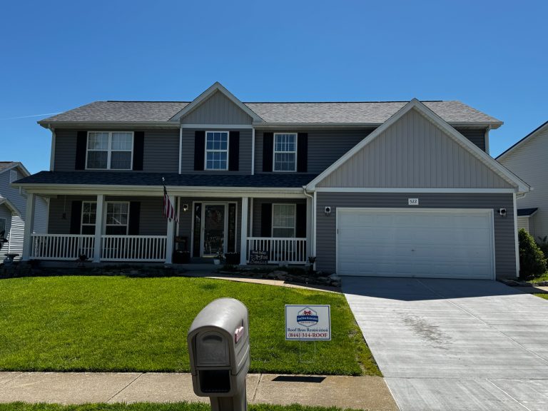 roof bros restoration illinois completed roof 014 - Roof Bros Restoration - roofing gallery wisconsin illinois Two-story residential home with gray siding, black shutters, covered front porch with American flag, two-car attached gara...