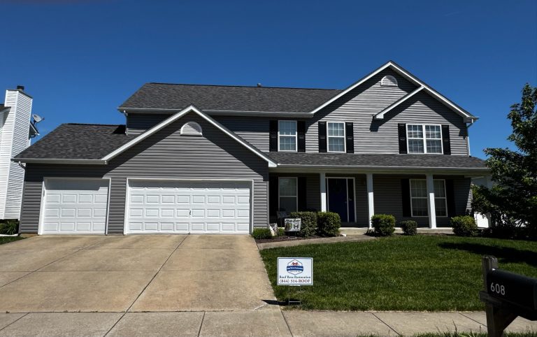 roof bros restoration illinois completed roof 016 - Roof Bros Restoration - roofing gallery wisconsin illinois Two-story residential home with gray siding, dark shingle roof, two attached garage doors of differing sizes, address numb...