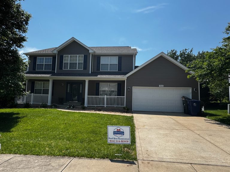roof bros restoration illinois completed roof 023 - Roof Bros Restoration - roofing gallery wisconsin illinois Two-story residential home with brown siding, covered front porch with white railings, two-car attached garage, dark shing...
