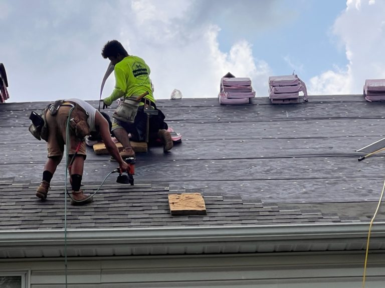 roof bros restoration illinois roof install 002 - Roof Bros Restoration - roofing gallery wisconsin illinois Two roofing workers, one in a green shirt with a logo and one in a brown shirt, install new asphalt shingles on a resident...
