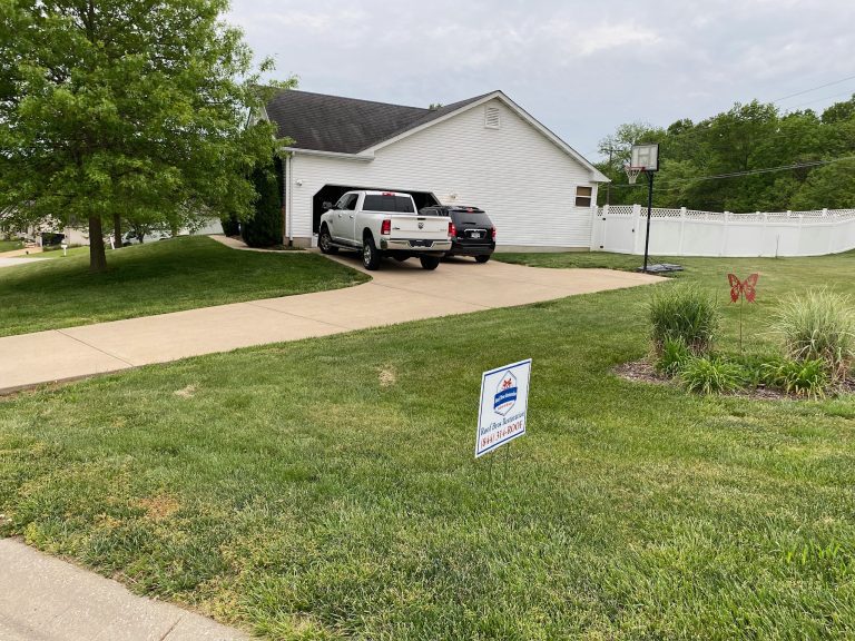 roof bros restoration illinois yard sign 002 - Roof Bros Restoration - roofing gallery wisconsin illinois A white pickup truck parked in front of an open garage at a white single-story house, with a Roof Bros Restoration yard si...