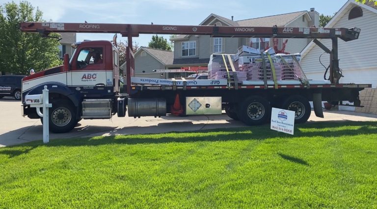 roof bros restoration jobsite 012 - Roof Bros Restoration - roofing gallery wisconsin illinois A flatbed ABC Supply truck labeled ROOFING / SIDING / WINDOWS is parked on a residential street loaded with roofing materi...