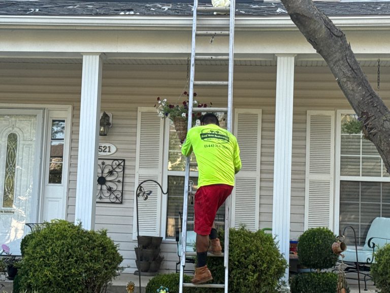 roof bros restoration roof inspection 001 - Roof Bros Restoration - roofing gallery wisconsin illinois A worker in a yellow-green high-visibility long-sleeve shirt with red shorts and tan work boots climbing an extension ladd...