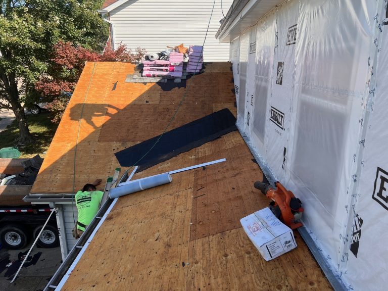 roof bros restoration roof install 002 - Roof Bros Restoration - roofing gallery wisconsin illinois A residential roof tear-off in progress shows exposed plywood decking, stacked shingle bundles, and a section of new under...