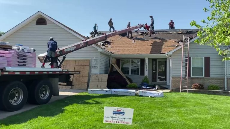 roof bros restoration video poster roof install 007 - Roof Bros Restoration - roofing gallery wisconsin illinois Crew of multiple workers on the roof of a single-story home with a red ABC conveyor delivering materials from a flatbed tr...