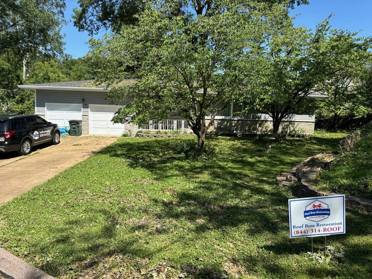 roof bros restoration yard sign 002 - Roof Bros Restoration - roofing gallery wisconsin illinois A single-story home with an attached garage and a Roof Bros Restoration yard sign in the foreground lawn, with a dark SUV...