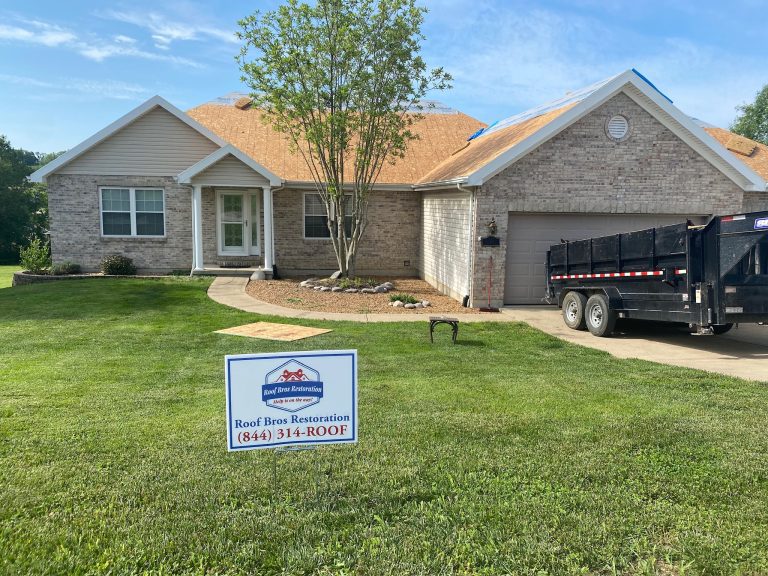 roof bros restoration yard sign 004 - Roof Bros Restoration - roofing gallery wisconsin illinois A one-story brick home with a roof tear-off in progress showing exposed wood decking, a Roof Bros Restoration yard sign wi...